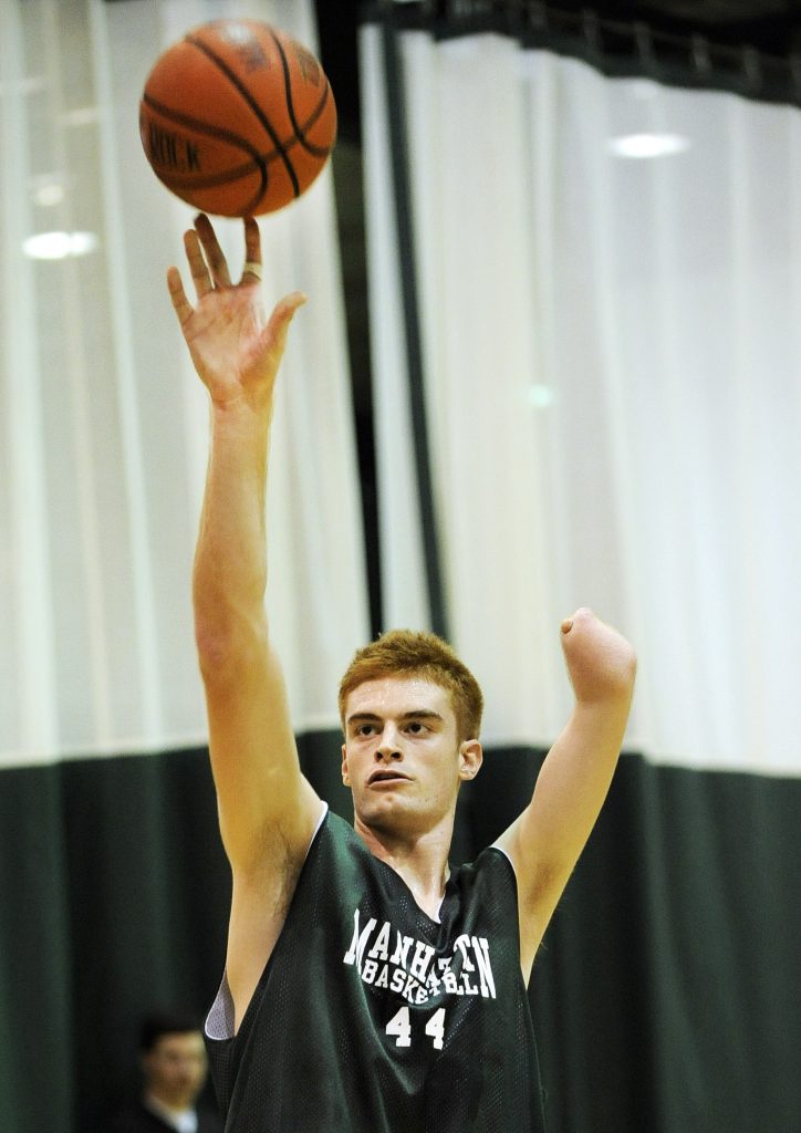 Manhattan College center Kevin Laue practices with his team Friday, Sept. 25, 2009 in the Bronx borough of New York. Born without a left hand, the 6-foot-11 center from Pleasanton, Calif., is now a freshman at Manhattan College, having earned a scholarship to play for the Jaspers and a chance to live out the dream of anyone who has been told they couldn't play a sport they loved because of a physical defect. (AP Photo/Stephen Chernin)